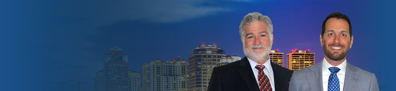 Attorneys in front of West Palm Beach, Florida skyline and city lights as night falls