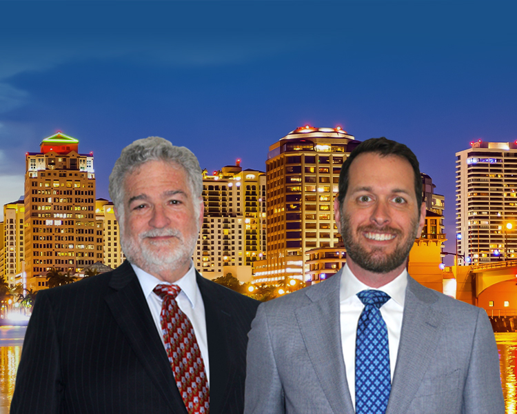 Attorneys in front of West Palm Beach, Florida skyline and city lights as night falls